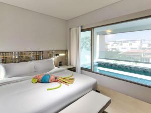 a bedroom with a bed with a fish on it at Veranda Resort Pattaya - MGallery Collection, Accor Hotel in Jomtien Beach