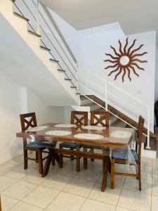 a dining room with a table and chairs and a staircase at White N Villa in Wadduwa +10 photos