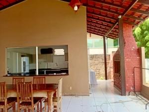 a dining room with a table and chairs at Casa Pé na Areia in Santarém