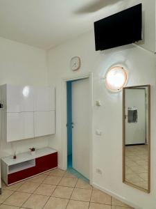 a room with a mirror and a tv on the wall at Aparthotel Dergano 3 near metro stop in Milan