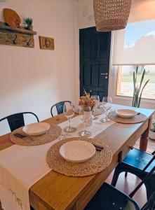 a wooden table with plates and wine glasses on it at Antigua Estación in Esquel