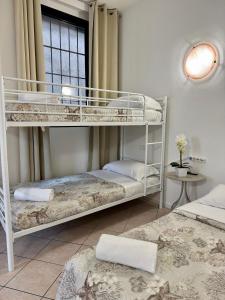 two bunk beds in a room with a window at Aparthotel Dergano 3 near metro stop in Milan