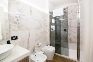 a bathroom with a shower and a toilet and a sink at Residenza sul mare 2 in Naples +14 photos