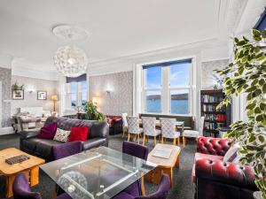 a living room with couches and a table at No. 1 Charlotte Street in Port Ellen
