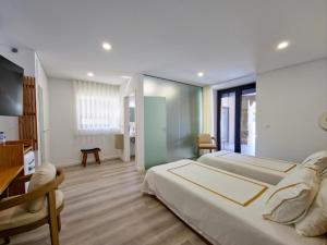 a large bedroom with a large bed and a desk at SOUTELO House in Grovelas +35 photos