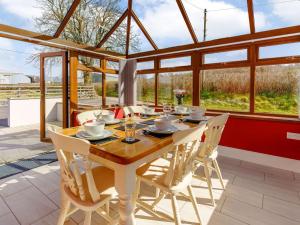 a dining room with a wooden table and chairs at 3 Bed in Lampeter 86506 in Cellan +38 photos