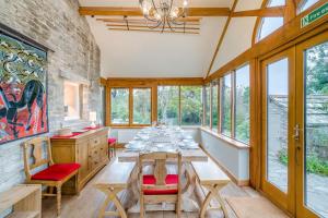 a dining room with a table and chairs and windows at 5 Bed in Corfe Castle DC061 in Corfe Castle