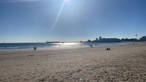 a group of people walking on the beach at Jungle, chambre spacieuse au coeur des sables in Les Sables-dʼOlonne +4 photos