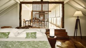 a bedroom with a bed and a dog in a room at Santa Teresa Hotel Rio de Janeiro - MGallery Collection in Rio de Janeiro +151 photos