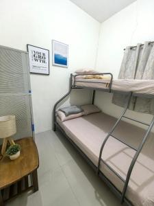 a room with two bunk beds and a table at Your Home in Tagum City - Perfect for Families in San Isidro