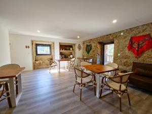 a living room with a table and chairs and a couch at SOUTELO House in Grovelas