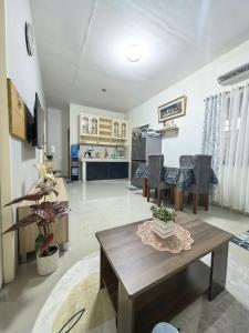 a living room with a table and a kitchen at Your Home in Tagum City - Perfect for Families in San Isidro