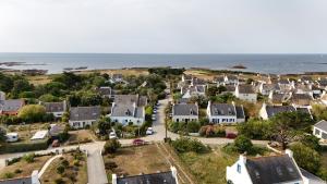 an aerial view of a residential neighborhood next to the ocean at Loc' Maria - Grands Sables in Groix