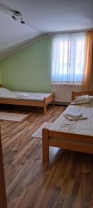 a room with two beds and a window at Apartman Marija 2 in Kraljevo +2 photos