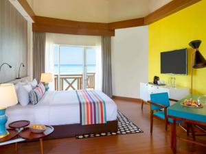 a bedroom with a bed and a view of the ocean at Mercure Maldives Kooddoo - Adults - Only Escape - 50 percent off Transfers in Gaafu Alifu Atoll