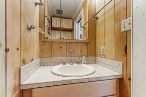a bathroom with a sink and a mirror at Valhalla in Rockaway Beach +25 photos