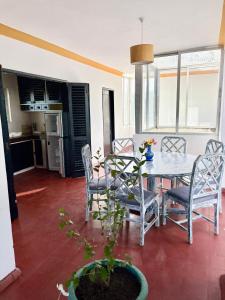 a dining room with a table and chairs at Wayside Beach Apartments in Diani Beach