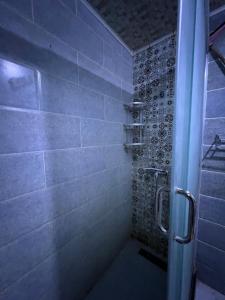 a bathroom with a shower with a blue shower curtain at Santa View oran in Oran +27 photos