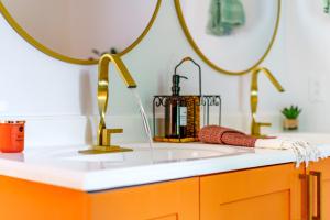 a bathroom with a sink and a mirror at Prime Location Top Rated Clean Parking Free! in Columbus +131 photos