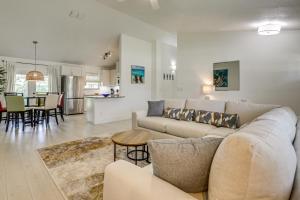 a living room with a couch and a table at Less Than 1 Mi to Butler Beach! Home with Backyard Oasis in Butler Beach