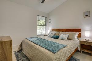 a bedroom with a large bed and a window at Less Than 1 Mi to Butler Beach! Home with Backyard Oasis in Butler Beach