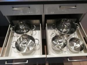 four pots and pans on a stove in a kitchen at Himmelthal Apartment in Eschau +14 photos