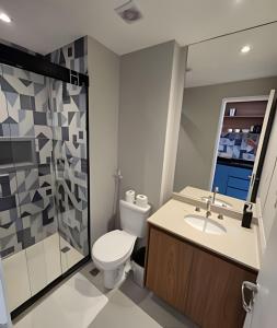 a bathroom with a toilet and a sink and a shower at Lofts | Consolação | 3 min Metrô in Sao Paulo