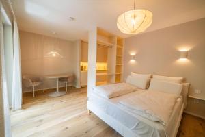 a small bedroom with a bed and a table at Lindgold in Munich