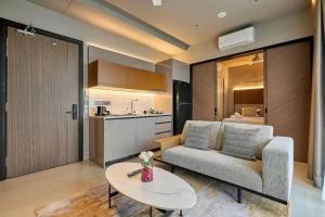 a living room with a couch and a table at Antara Genting by Enigma in Genting Highlands