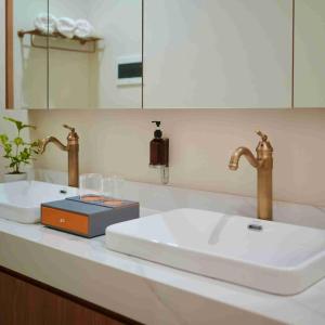a bathroom sink with two faucets on a counter at La Manna Events and Leisure Place 