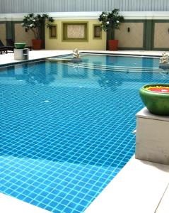 a swimming pool with blue tiles on the floor at Ebina House - SHA Extra Plus in Bangkok