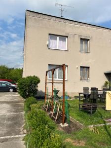 a house with a table and chairs in front of it at Monstera III - industrial in Kolín