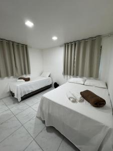 Una cama o camas en una habitación de Rede de Hotel 99