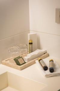 a white counter with a wooden tray with products on it at Hotel Masía Bellver in Benicàssim