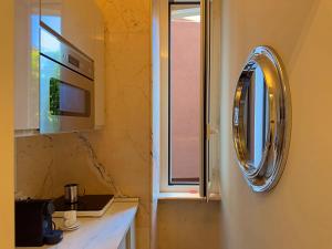 een keuken met een wastafel, een magnetron en een raam bij Appartme Stampa 2 in Milaan