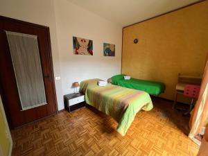 a bedroom with a bed and a door to a room at Paolo&SilviaHost in Seriate