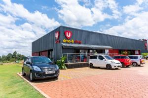two cars parked in a parking lot in front of a shop at BethelHomes in Tatu City