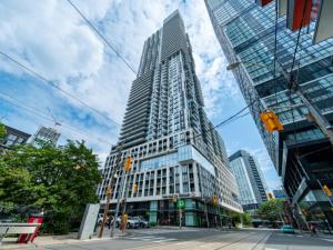 a tall building on a city street with at 2br Luxury & Modern Suite 5 Minutes from Eaton Center in Toronto