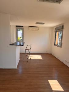 an empty room with a chair in the middle at Appartement face Aéroport Marseille in Vitrolles