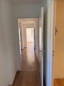 a hallway with an open door to a room at Appartement face Aéroport Marseille in Vitrolles