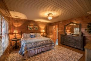 a bedroom with a bed and a dresser and a mirror at Alpine Vista in Blowing Rock