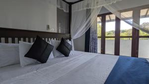 Ένα ή περισσότερα κρεβάτια σε δωμάτιο στο Echo 1 Tangalle