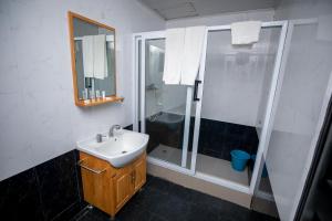 a bathroom with a sink and a shower at Busua Beach Resort in Busua +25 photos