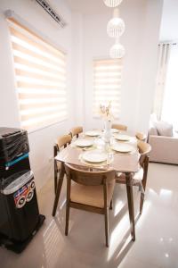 a dining room with a table and chairs and a stove at Casa de Amor Modern Comfort across the pool in Dauis