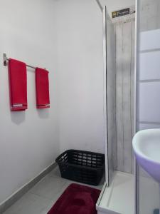a bathroom with two red towels and a sink at Luci's House B in São Jorge +15 photos