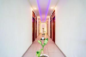 a hallway with a purple light on the ceiling at Hotel O Blue Stone Near Singapore Mall Lucknow in Gomti Nagar