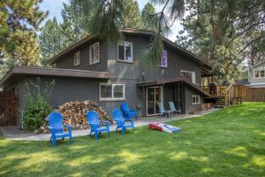 a house with blue chairs in the yard at Bluebird Day - Brooks House in Deschutes River Woods