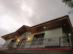 a building with a sign on the side of it at Samaira home stay in Bīr