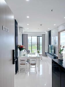 a kitchen and dining room with a table and chairs at An Nam Apartment in Thôn Văn Dương