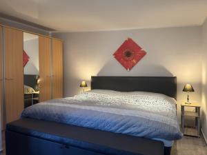 a bedroom with a bed with a red star on the wall at Ferienhaus mit Kamin in Sternberg in Sternberg